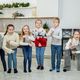 Merry Christmas and Happy Holidays. Children having fun and dance at Christmas. - PhotoDune Item for Sale