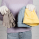 Cropped view of young woman holding soft gloves and hats on white background - PhotoDune Item for Sale