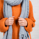Cropped view of woman in orange knitted sweater and grey scarf on white background - PhotoDune Item for Sale