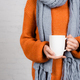 Cropped view of woman in knitted wear holding mug on white background - PhotoDune Item for Sale