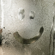 Smiley drawn on the foggy glass on window,wet glass - PhotoDune Item for Sale