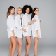 slim multiethnic women in white shirts posing on heels on grey - PhotoDune Item for Sale