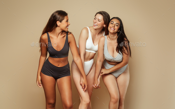 Group of laughing millennial different body and ethnicity women in underwear  have fun, enjoy body Stock Photo by Prostock-studio