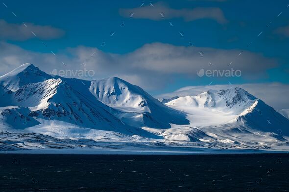 Several snow-covered mountains with a smooth bowl of deep snow near the island of Svalbard