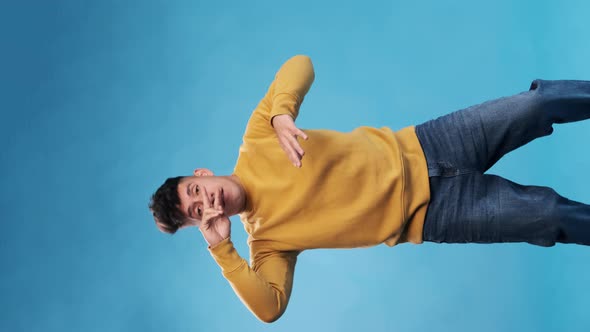 Happy and cheerful man enjoying while dancing against an isolated background. alt