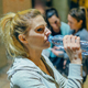 Portrait of tired woman runner drinking water after training with her friends at night on town. - PhotoDune Item for Sale