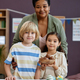 Black woman as female teacher posing with cute little kids in preschool - PhotoDune Item for Sale