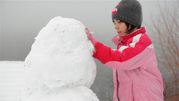 Girl Making A Snowman