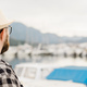 Banner rear view millennial man wearing hat with yachts and marina background with copy space and - PhotoDune Item for Sale