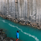 A man standing next to the turquoise water in the canyon and admiring nature. - PhotoDune Item for Sale