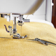 Modern Sewing Machine With Yellow Velours Fabric Close Up - PhotoDune Item for Sale