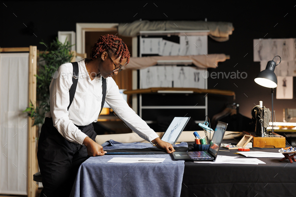 Seamstress using measuring tape Stock Photo by DC_Studio