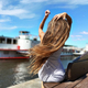 Young Woman With Long Hair In Wind Sits In Front Of White Ship On River On Blue Cloudy Sky Backgroun - PhotoDune Item for Sale