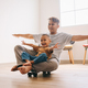 Cheerful Father and Son Sliding with Skatebo - PhotoDune Item for Sale