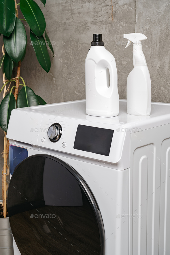 Washing liquid detergents on washing machine in a laundry room Stock