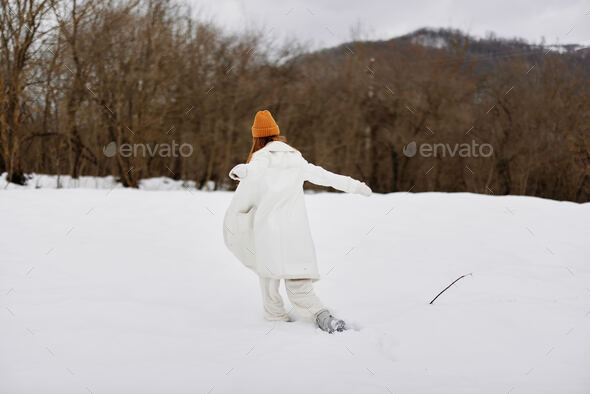 woman in winter clothes in a hat fun winter landscape There is a lot of snow  around Stock Photo by shotprime