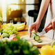 Close up on young housewife woman hands slicing cucumber with kitchen knife - PhotoDune Item for Sale