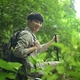 Happy young male hiker with backpack trekking in forest, exploring nature. - PhotoDune Item for Sale