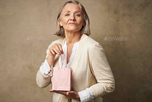 Elderly woman with gifts, Stock image