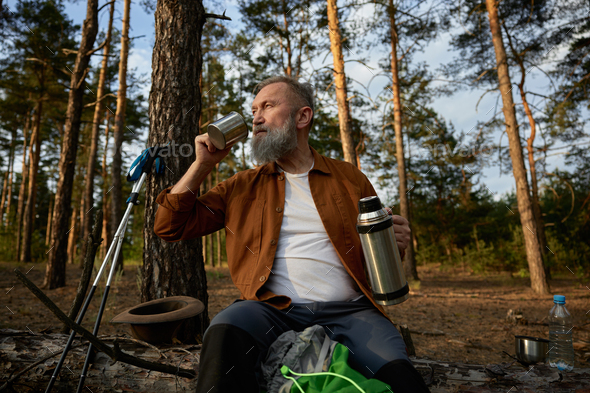 Hot Tea In Thermos For A Walk In The Woods While Resting Stock