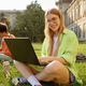 Portrait of smart millennial student using laptop while studying outdoors - PhotoDune Item for Sale