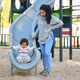 Dominican mother playing with her toddler daughter at the slide in a park. - PhotoDune Item for Sale