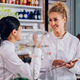 Pharmacists in lab coats are standing together in a pharmacy - PhotoDune Item for Sale