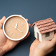House and clock in hands.  - PhotoDune Item for Sale