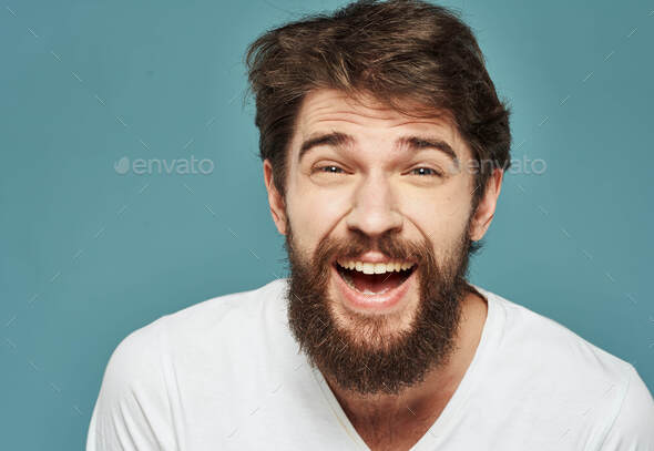 Happy man joy delight emotions blue background thick beard