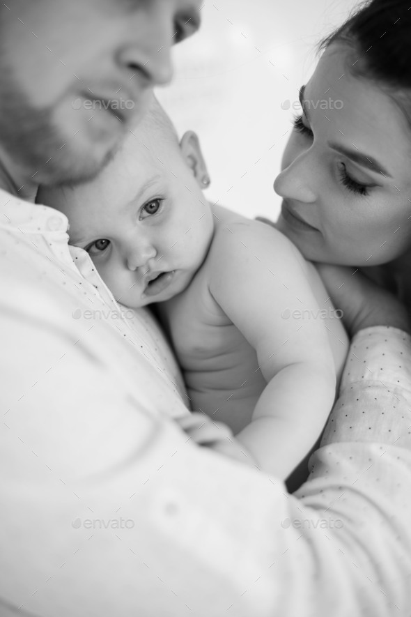 Naked Baby Girl Being Embraced By Loving Parents Indoors Stock Photo By