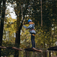 teenage boy in outdoor adventure park passing obstacle course. high rope park - PhotoDune Item for Sale
