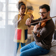 Young father teaching his adopted daughter to play violin. Single parent child happiness concept. - PhotoDune Item for Sale