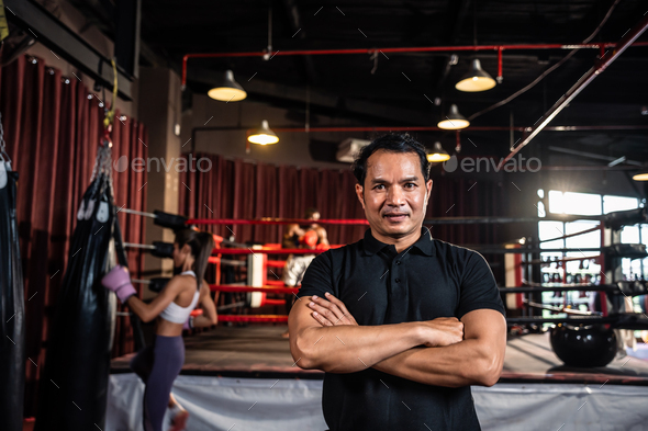 Portrait of Asian male referee enforces the rules of the boxing match.