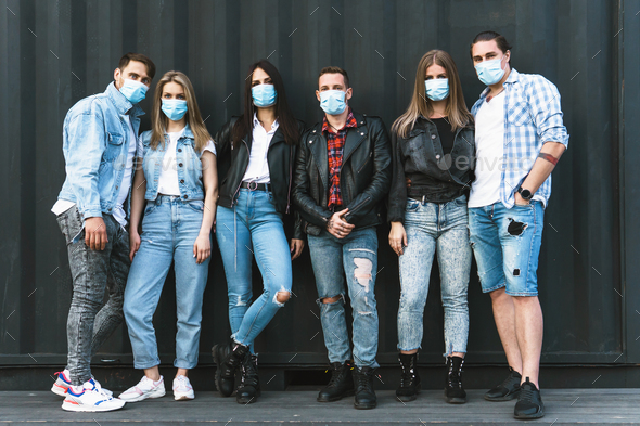 Group of friends wearing prevention masks during their meeting outdoors.