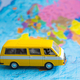 Yellow bus on satin. World map, close-up - PhotoDune Item for Sale