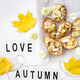 baked pears with brie cheese and nuts on a background of autumn yellow leaves, the inscription - PhotoDune Item for Sale