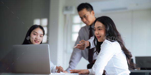 Asian business team meeting to analyze and discuss the situation on the financial report in the - Stock Photo - Images