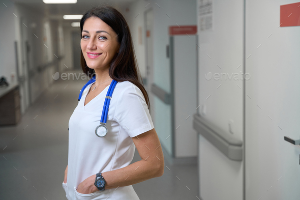 Smiling clinic employee in a bright hospital corridor Stock Photo by ...