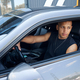 Qualified African American driver testing new car from auto-salon - PhotoDune Item for Sale