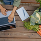 Top view of female vegetables farm owner working on laptop with clients orders  - PhotoDune Item for Sale