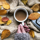 Overhead View Of Female Hand Holding Coffee Cup Surrounded By Yellow  Autumn Leaves And Alarm Clock - PhotoDune Item for Sale