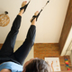 first person view of female legs training with pulleys on exercise machine at home - PhotoDune Item for Sale