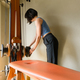 Caucasian woman placing dumbbell on training machine at home - PhotoDune Item for Sale