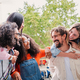 Group of positive joyful multiracial people giving piggyback ride while enjoying good time outside - PhotoDune Item for Sale