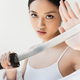 Young japanese woman touching sword on blurred foreground isolated on grey - PhotoDune Item for Sale