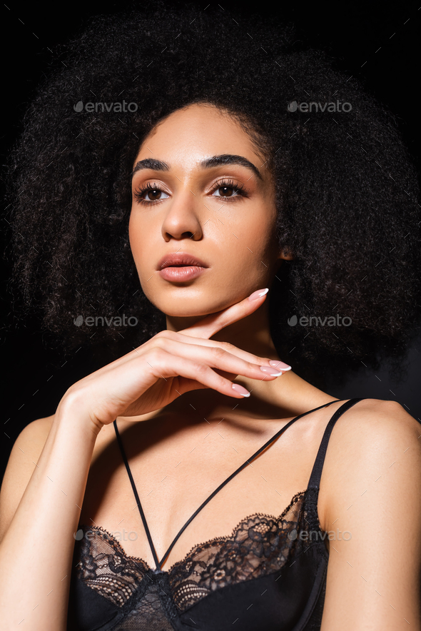 Pretty african american woman in lingerie isolated on black Stock Photo by  LightFieldStudios