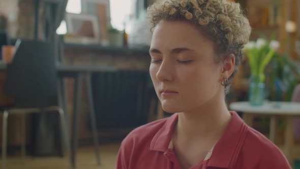 Girl with Prosthetic Arm Practicing Yoga Meditation at Home alt