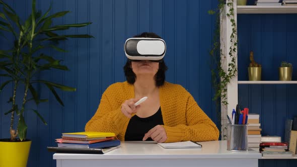 Middle Aged Woman Wearing Vr Goggle 3d Visualization and Exploring in Metaverse Futuristic Lifestyle alt