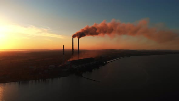 Aerial Drone View: High Chimney Pipes with dirt smoke from Coal Power Plant.