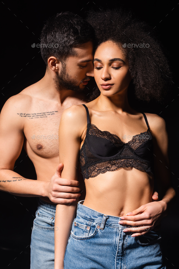 sexy woman in red bra and panties hugging handsome man isolated on black  Stock Photo by LightFieldStudios